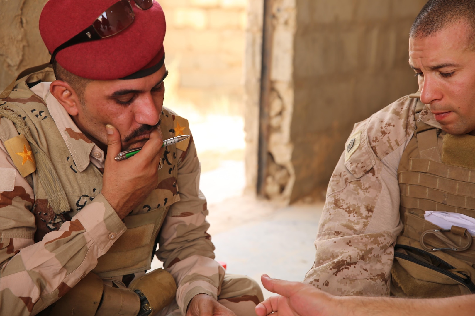 U.S. Marine Corps Gunnery Sgt. Ryan Kirkham, the combined anti-armor team platoon sergeant attached to Task Force Al Asad with 1st Battalion, 7th Marine Regiment, Special Purpose Marine Air-Ground Task Force-Crisis Response-Central Command, conducts a de-brief with Iraqi officer of the 7th Iraqi Infantry Division at Al Asad Air Base, Iraq, July 7, 2017. These Marines are part of the Task Force’s coalition security force team in charge of providing security to the base and personnel onboard. Task Force Al Asad’s mission is to advise and assist and build partner capacity with the Iraqi Security Forces in Al Anbar province in support of Combined Joint Task Force-Operation Inherent Resolve, the global coalition to defeat ISIS in Iraq and Syria. (U.S. Marine Corps photo by 1st Lt. Dave Williams)