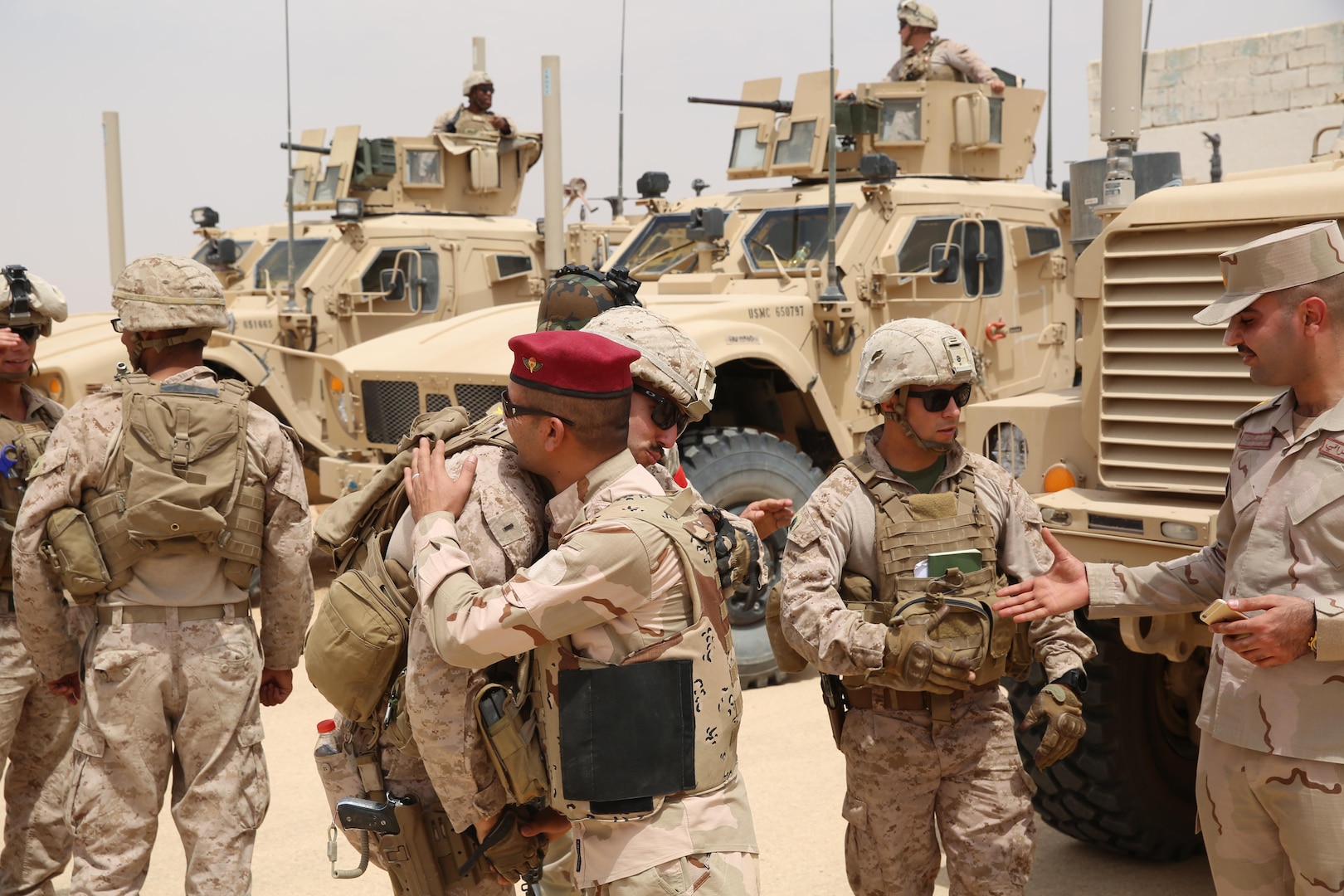 U.S. Marine Corps 1st Lt. Christian Castilla and Gunnery Sgt. Ryan Kirkham, the combined anti-armor team platoon commander and platoon sergeant attached to Task Force Al Asad with 1st Battalion, 7th Marine Regiment, Special Purpose Marine Air-Ground Task Force-Crisis Response-Central Command, conclude a training evolution with Iraqi officers with the 7th Iraqi Infantry Division at Al Asad Air Base, Iraq, July 7, 2017. These Marines are part of the Task Force’s coalition security force team in charge of providing security to the base and personnel onboard. Task Force Al Asad’s mission is to advise and assist and build partner capacity with the Iraqi Security Forces in Al Anbar province in support of Combined Joint Task Force-Operation Inherent Resolve, the global coalition to defeat ISIS in Iraq and Syria. (U.S. Marine Corps photo by 1st Lt. Dave Williams)