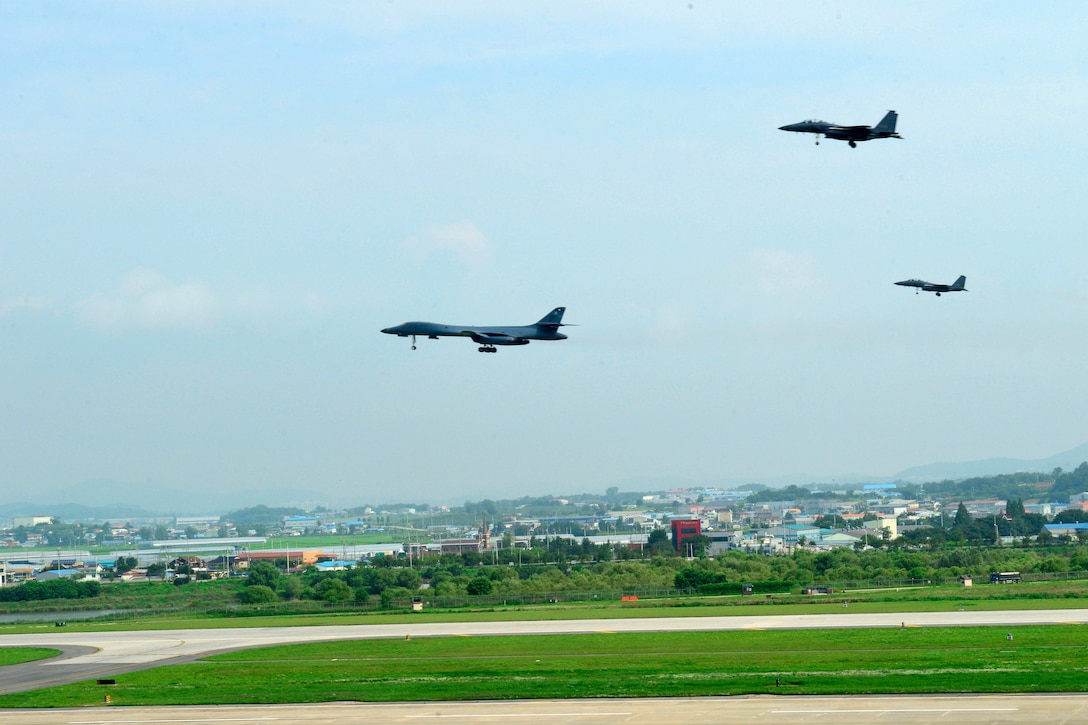 A U.S. Air Force B-1B Lancer and two fighter jets perform a low pass over Osan Air Base, South Korea, July 30, 2017. The Lancer crew is assigned to the 9th Expeditionary Bomb Squadron, deployed from Dyess Air Force Base, Texas. Air Force photo by Tech. Sgt. Benjamin Wiseman