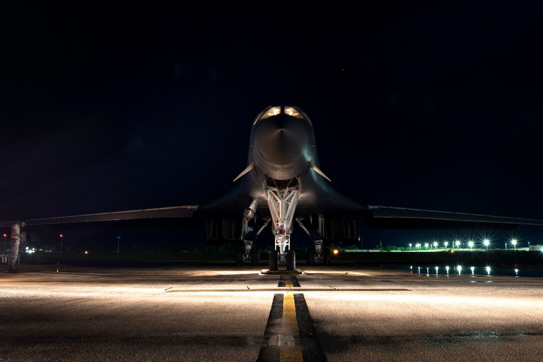 An airman performs the final checks on an Air Force B-1B Lancer before taking off on a 10-hour mission from Andersen Air Force Base, Guam, into Japanese airspace and over the Korean Peninsula, July 30, 2017. The Lancer crew is assigned to the 9th Expeditionary Bomb Squadron, deployed from Dyess Air Force Base, Texas.  Air Force photo by Tech. Sgt. Richard P. Ebensberger