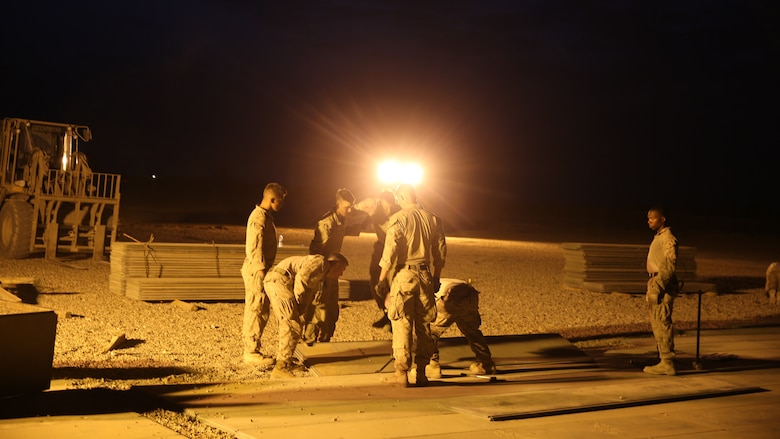U.S. Marines attached to Task Force Al Asad with Marine Wing Support Squadron (MWSS) 372, Special Purpose Marine Air-Ground Task Force-Crisis Response-Central Command, lay expeditionary airfield matting in support of engineering operations at Al Asad Air Base, Iraq, July 7, 2017. The Marines of the Engineering Detachment work daily on a variety of engineer tasks in support of the master base plan for Task Force Al Asad. Task Force Al Asad’s mission is to advise and assist  and build partner capacity with the Iraqi Security Forces in Al Anbar province in support of Combined Joint Task Force-Operation Inherent Resolve, the global coalition to defeat ISIS in Iraq and Syria. (U.S. Marine Corps photo by 1st Lt. Dave Williams)