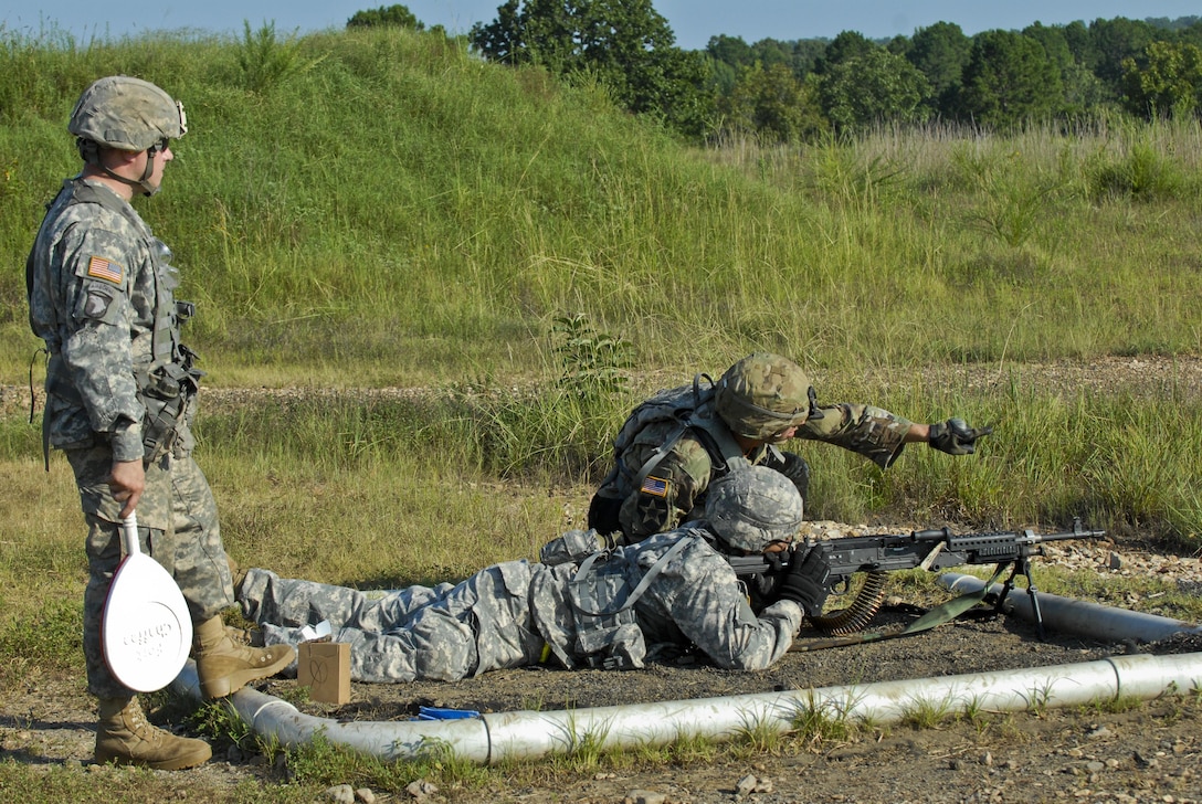 Sgt. Ryan Wells and Spc. John Hubbard are U.S. Army Reserve Soldiers with the 463rd FSC, Engineer Battalion, 411th Engineer Brigade, 412th Theater Engineer Command, preparing for a familiarization and qualify fire with the M240 machine gun during River Assault 2017 at Fort Chaffee Maneuver Center, Ark., July 25, 2017. River Assault 2017 is a two-week extended combat training exercise held July 15-28 focusing on technical skills, of various service members, culminating with the construction of a floating improved ribbon bridge across the Arkansas River.  (U.S. Army Reserve Photo by Staff Sgt. Roger Ashley)