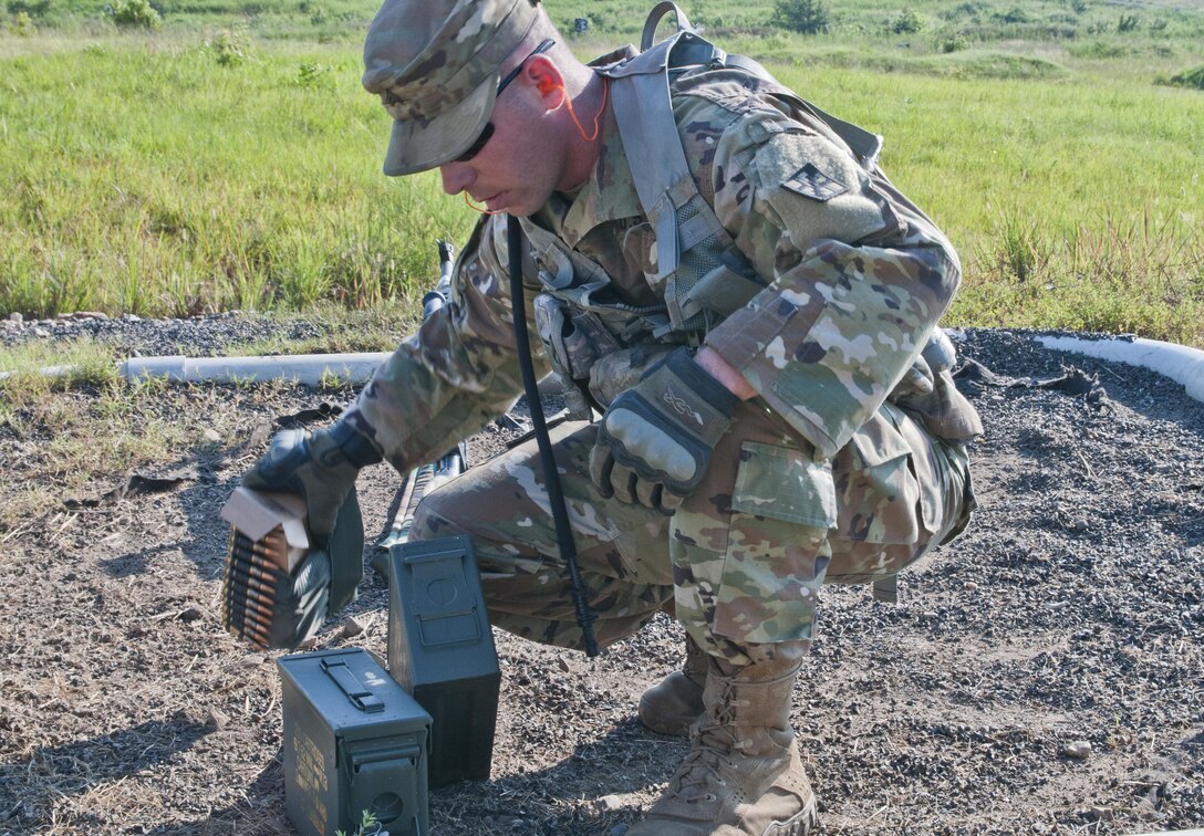 Sgt. Ryan Wells, a U.S. Army Reserve Soldier with the 463rd FSC, Engineer Battalion, 411th Engineer Brigade, 412th Theater Engineer Command, readies the ammo to familiarize with and qualify fire the M240 machine gun during River Assault 2017 at Fort Chaffee Maneuver Center, Ark., July 25, 2017. River Assault 2017 is a two-week extended combat training exercise held July 15-28 focusing on technical skills, of various service members, culminating with the construction of a floating improved ribbon bridge across the Arkansas River.  (U.S. Army Reserve Photo by Staff Sgt. Roger Ashley)