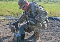 Sgt. Ryan Wells, a U.S. Army Reserve Soldier with the 463rd FSC, Engineer Battalion, 411th Engineer Brigade, 412th Theater Engineer Command, readies the ammo to familiarize with and qualify fire the M240 machine gun during River Assault 2017 at Fort Chaffee Maneuver Center, Ark., July 25, 2017. River Assault 2017 is a two-week extended combat training exercise held July 15-28 focusing on technical skills, of various service members, culminating with the construction of a floating improved ribbon bridge across the Arkansas River.  (U.S. Army Reserve Photo by Staff Sgt. Roger Ashley)