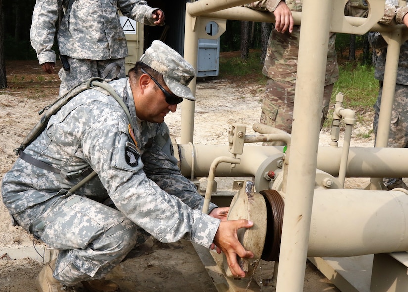 U.S. Army Reserve Master Sgt. Hector Guerrero, senior detachment sergeant with the 809th Quartermaster Liaison Detachment, inspects petroleum equipment during the two-week 2017 Quartermaster Liquid Logistics Exercise in Ft. Bragg, NC, Jul. 14 to 27, 2017.  QLLEX allows U.S. Army Reserve units to demonstrate their skills and provide real-world fuel and water support while training at the tactical, operational, and strategic level.  (U.S. Army Reserve Photo by Maj. Brandon R. Mace)