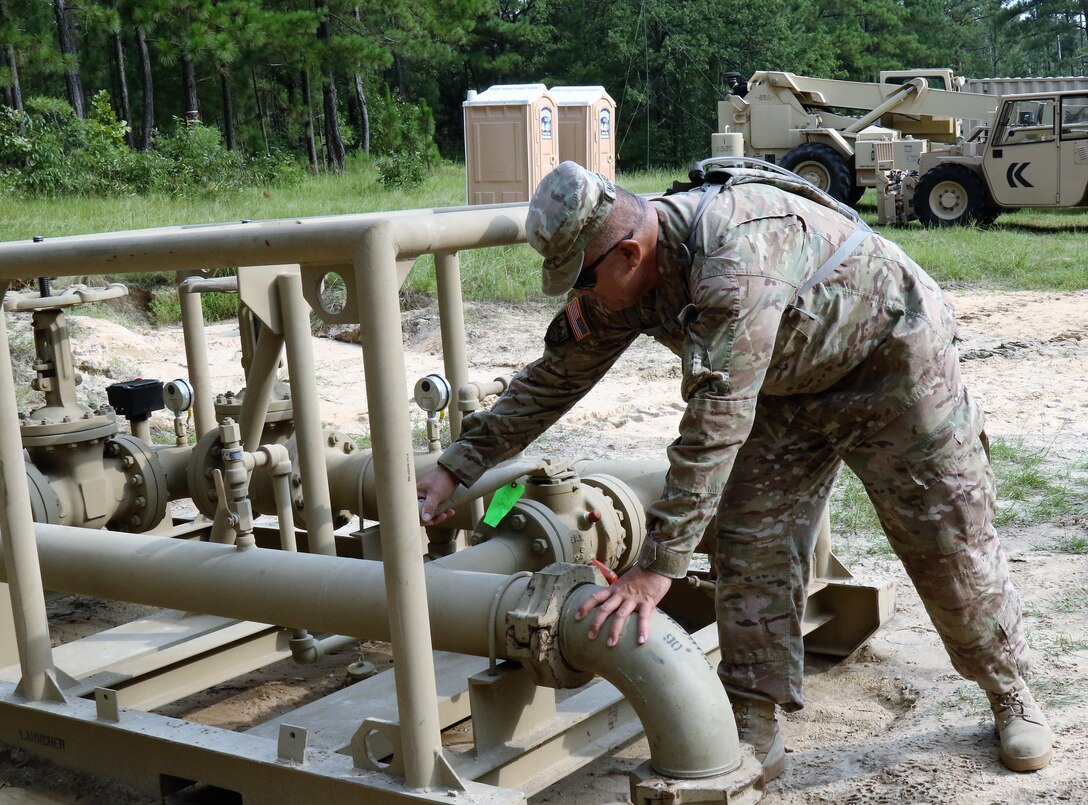 U.S. Army Reserve Sgt. 1st Class Pato Mareko, a requirements NCO with the 809th Quartermaster Liaison Detachment, inspects petroleum equipment during the two-week 2017 Quartermaster Liquid Logistics Exercise in Ft. Bragg, NC, Jul. 14 to 27, 2017.  QLLEX allows U.S. Army Reserve units to demonstrate their skills and provide real-world fuel and water support while training at the tactical, operational, and strategic level.  (U.S. Army Reserve Photo by Maj. Brandon R. Mace)