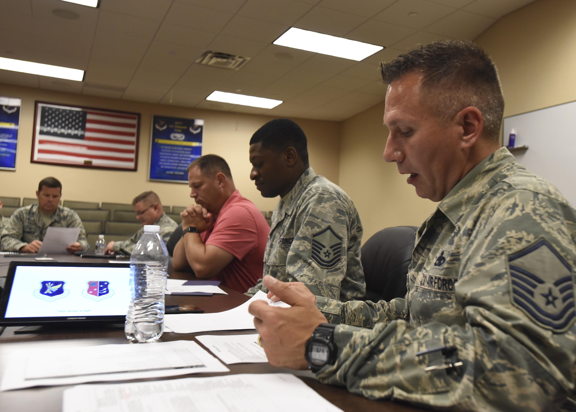 U.S. Air Force Master Sgt. Shawn McDuff, 305th Maintenance Squadron team lead, speaks with Air Force Col. Brian Daniels, 305th Maintenance Group commander, about creating an action plan to streamline processes at Joint Base McGuire-Dix-Lakehurst, New Jersey, July 27, 2017. The unit is set to begin a continuous process improvement initiative in September that will increase the efficiency of C-17 Globemaster III engine changes. (U.S. Air Force photo by Airman 1st Class Jessica Blair)