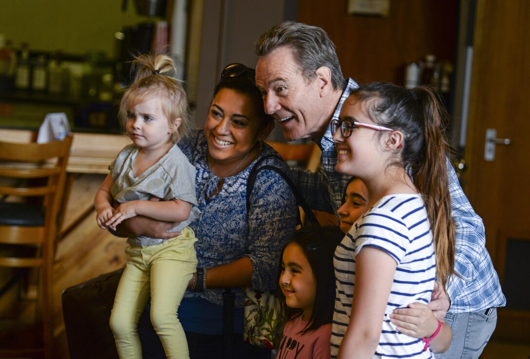 Actor Bryan Cranston takes a photo with members of Team Mildenhall July 29, 2017, during a United Service Organization Tour on RAF Mildenhall, England. Cranston started the tour off by visiting with Airmen and their families at the Bob Hope Community Center. (U.S. Air Force photo by Staff Sgt. Micaiah Anthony)