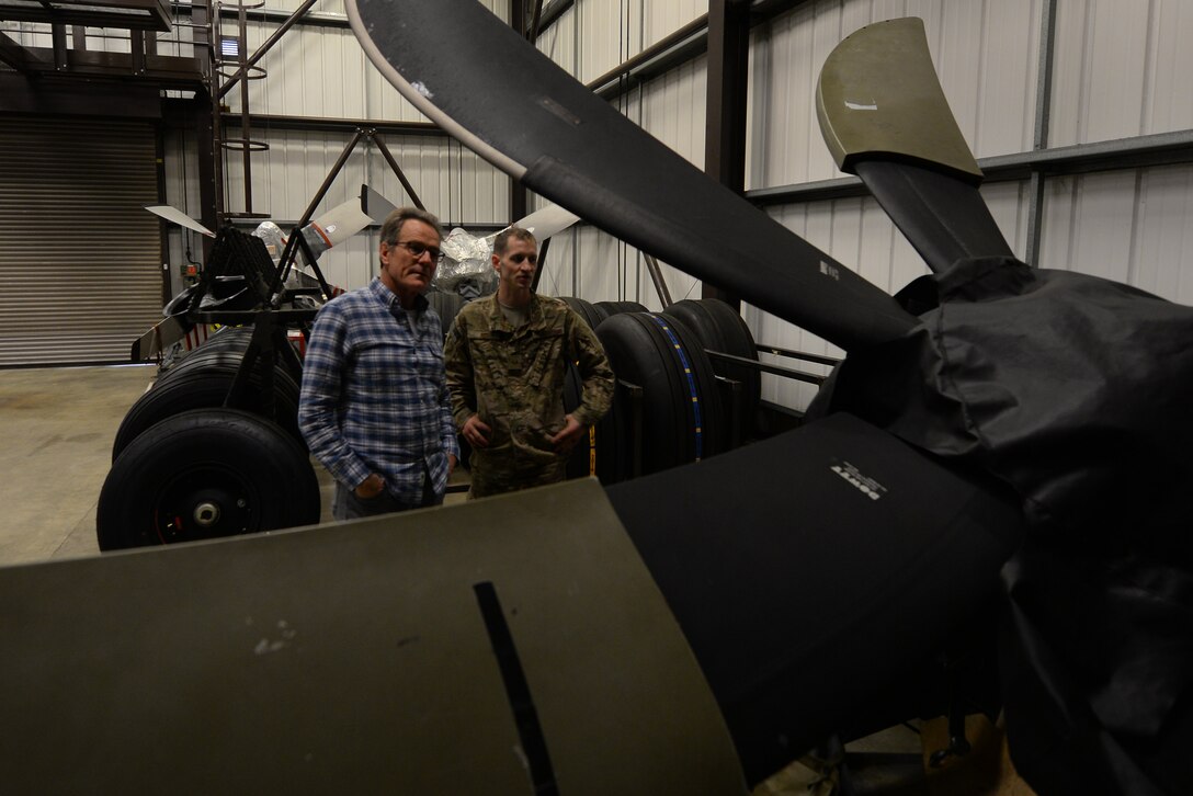A U.S. Air Commando from the 352nd Special Operations Aircraft Maintenance Squadron gives actor Bryan Cranston a tour of the decentralized material support section July 29, 2017, during a United Service Organization Tour on RAF Mildenhall, England. After visiting Airmen and their families at the Bob Hope Community Center, Cranston toured the base, dined with Airmen and made a visit to the 352nd SOMXG. (U.S. Air Force photo by Staff Sgt. Micaiah Anthony)