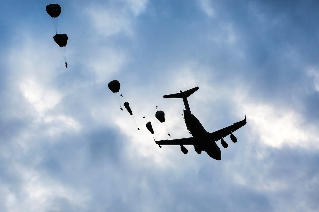 Paratroopers jump from a C-17 Globemaster while participating in a joint force entry during Exercise Saber Guardian at the Bezmer Training Area in Bezmer, Bulgaria, July 18, 2017. The paratroopers are assigned to the 173rd Airborne Brigade. Saber Guardian, held in location across Bulgaria, Hungary and Romania, included more than 25,000 participating troops from 22 allied and partner nations. Army photo by Sgt. Matthew Hulett
