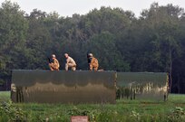 Three U.S. Army Soldiers from a Multi-Role Bridge Company kneel on top of an Improved Ribbon Bridge (IRB) Bay Section waiting to hook it up to a CH-47 Chinook of Company B, 7th (General Support Aviation) Battalion, 158th Aviation Regiment, 244th Aviation Brigade, Army Reserve Aviation Command during River Assault 2017 on Fort Chaffee Manuever Training Center, July 26, 2017. The Chinook dropped off the bay in the Arkansas River in order for the IRB to be built across the river, the culminating event of River Assault. Operation River Assault is one of the key training events that demonstrates that America’s Army Reserve is the most capable, combat ready, and lethal Federal Reserve Force in the history of the nation. (U.S. Army Reserve Photo by Sgt. 1st Class Clinton Wood)