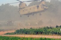 Three U.S. Army Soldiers from a Multi-Role Bridge Company run away from the roto wash of a CH-47 Chinook of Company B, 7th (General Support Aviation) Battalion, 158th Aviation Regiment, 244th Aviation Brigade, Army Reserve Aviation Command as it begins to lift an Improved Ribbon Bridge (IRB) Bay Section during River Assault 2017 on Fort Chaffee Manuever Training Center, July 26, 2017. The Chinook dropped off the bay in the Arkansas River in order for the IRB to be built across the river, the culminating event of River Assault. Operation River Assault is one of the key training events that demonstrates that America’s Army Reserve is the most capable, combat ready, and lethal Federal Reserve Force in the history of the nation. (U.S. Army Reserve Photo by Sgt. 1st Class Clinton Wood)