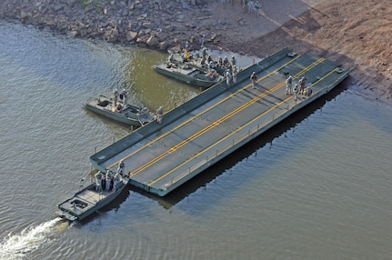 MKII Bridge Erection Boats position three Improved Ribbon Bridge (IRB) Bay Sections on the shore of the Arkansas River during River Assault 2017 on Fort Chaffee Manuever Training Center, July 26, 2017. Several of the Bays hooked together formed a IRB across the river, the culminating event of River Assault. Operation River Assault, July 26, 2017. Operation River Assault is one of the key training events that demonstrates that America’s Army Reserve is the most capable, combat ready, and lethal Federal Reserve Force in the history of the nation. (U.S. Army Reserve Photo by Sgt. 1st Class Clinton Wood)
