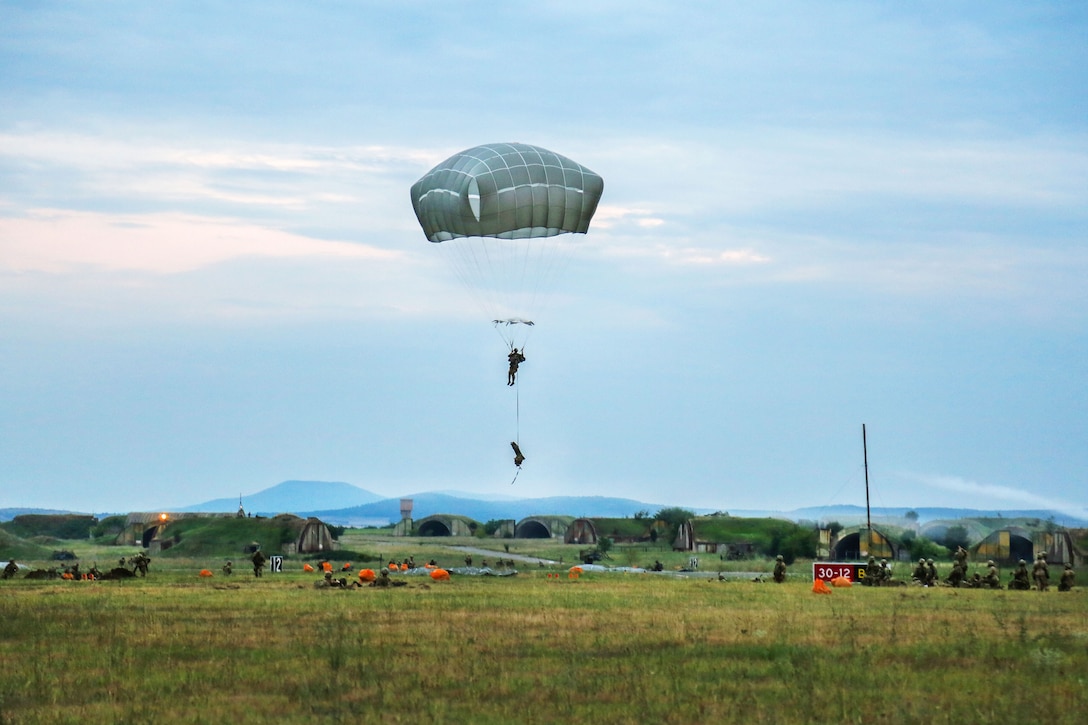 A paratrooper prepares to land at the drop zone after jumping from a C-17 Globemaster during Exercise Saber Guardian at the Bezmer Training Area in Bezmer, Bulgaria, July 18, 2017. Army photo by Sgt. Matthew Hulett