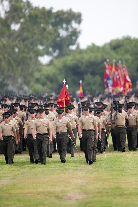 CAMP PENDLETON, CALIF. - U.S. Marines with 1st Marine Logistics Group march onto the Page Field House parade deck during the 1st MLG change of command ceremony at Camp Pendleton July 28, 2017.  Approximately 8,000 Marines and Sailors serve numerous occupational specialties within 1st MLG, encompassing six functions of logistics: supply, maintenance, transportation, general engineering, health services, and command services. (U.S. Marine Corps photo by Sgt. Rodion Zabolotniy)