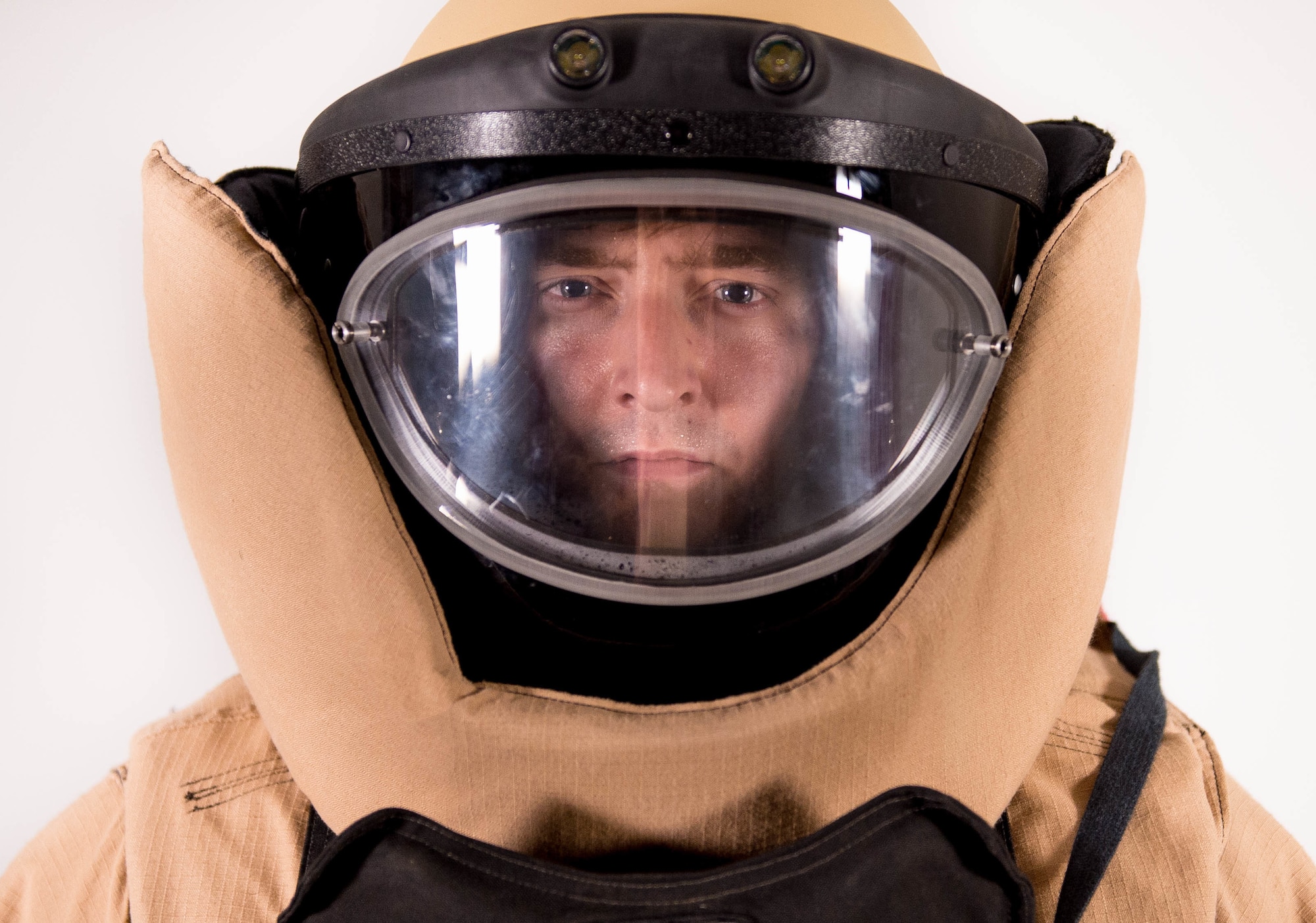 Staff Sgt. Jeffrey Knelange, 56th Civil Engineer Squadron EOD training NCO, stands in his bomb suit at Luke Air Force Base, Ariz., July 10, 2017. Knelange has learned to balance the demands of being an EOD professional while being a key component to the success of the Luke Thunderbolts Hockey team which is a vital part of his comprehensive fitness. (U.S. Air Force photo/Staff Sgt. Jensen Stidham)