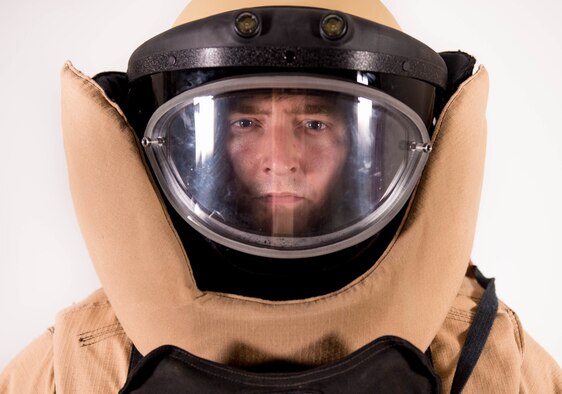 Staff Sgt. Jeffrey Knelange, the 56th Civil Engineer Squadron Explosive Ordnance Disposal training NCO, stands in his bomb suit at Luke Air Force Base, Ariz., July 10, 2017. Knelange has learned to balance the demands of being an EOD professional while being a key component to the success of the Luke Thunderbolts Hockey team which is a vital part of his comprehensive fitness. (U.S. Air Force photo/Staff Sgt. Jensen Stidham)