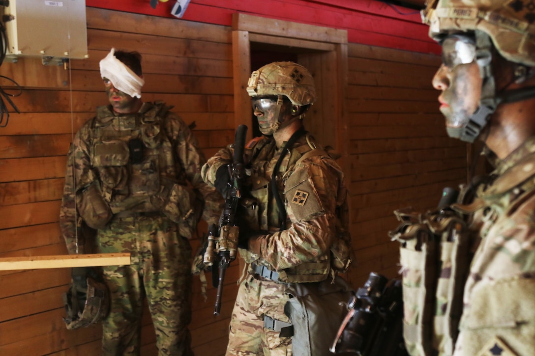 Soldiers infiltrate a building with a simulated casualty during a live-fire exercise at the Grafenwoehr Training Area, Germany, July 28, 2017. Army photo by Staff Sgt. Ange Desinor