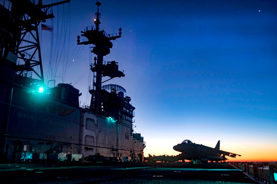 Aircraft sit idle on the deck of the amphibious assault ship USS Bonhomme Richard in the Coral Sea as the sun rises, July 29, 2017. Navy photo by Petty Officer 3rd Class William Sykes