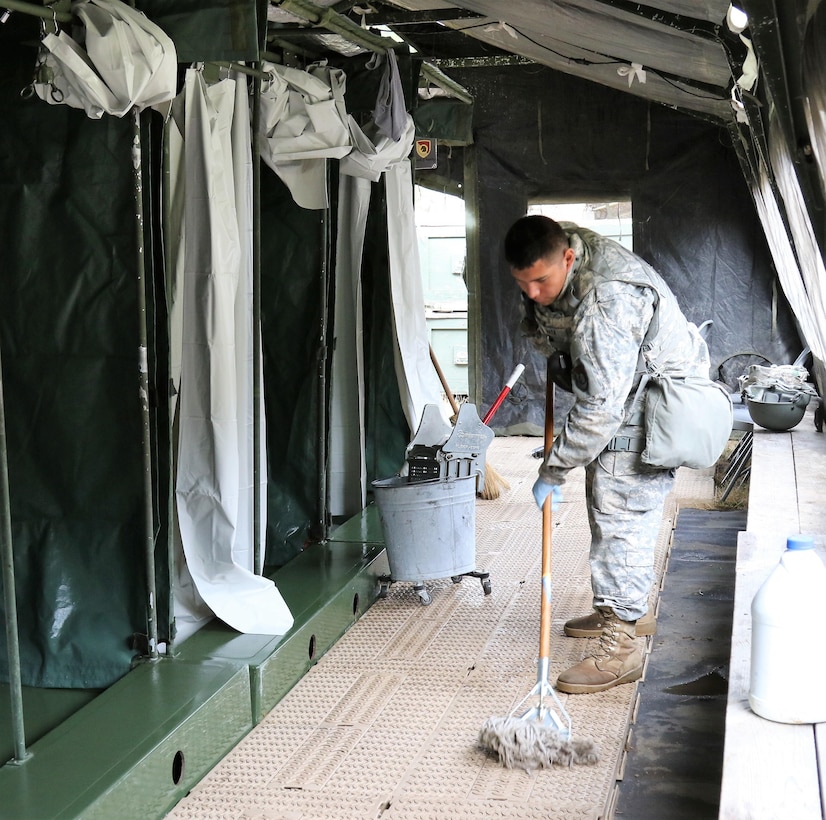 U.S. Army Reserve Spc. Domingo Mata, a shower/laundry and clothing repair specialist with the 340th Quartermaster Company, mops a shower floor during the two-week 2017 Quartermaster Liquid Logistics Exercise at Joint Base Lewis McChord, WA, Jul. 14 to 27, 2017.  QLLEX allows U.S. Army Reserve units to demonstrate their skills and provide real-world fuel and water support while training at the tactical, operational, and strategic level.  (U.S. Army Reserve Photo by Maj. Brandon R. Mace)