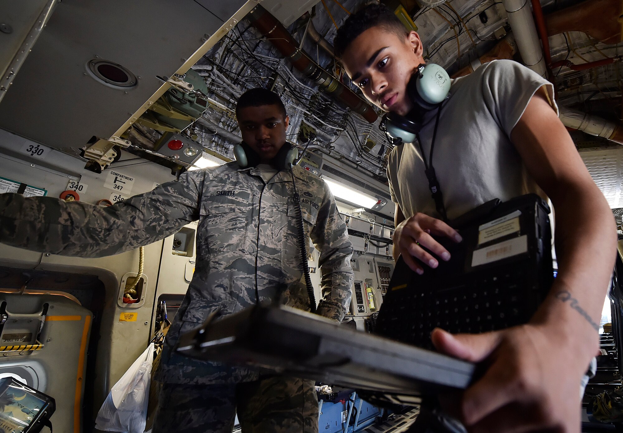 Airman 1st Class Jamar Finnie, right, 437th Aircraft Maintenance Squadron instrument and flight control systems apprentice and Tech. Sgt. Timothy Smith, 437th AMXS, conduct prelaunch checks for a C-17 Globemaster III here, prior to departing for Joint Base Lewis-McChord, Washington State, in support of Exercise Mobility Guardian July 31. Mobility Guardian is designed to enhance the capabilities of mobility Airmen to succeed in dynamic threat environments. The exercise features more than 3,000 participants and involves 25 countries from July 31 to Aug. 11. (U.S. Air Force photo by Staff Sgt. Christopher Hubenthal)