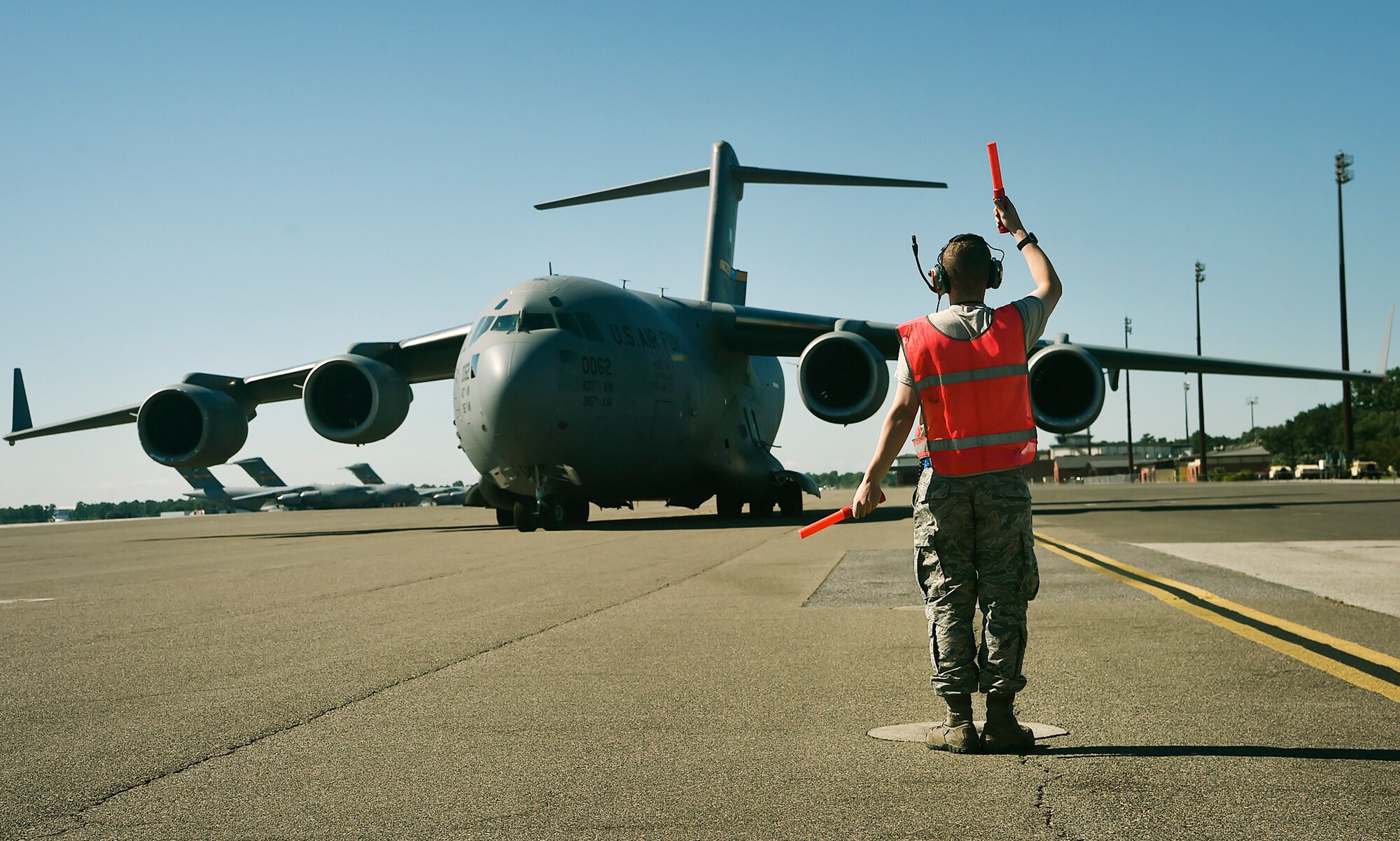 Airman 1st Class David Jackson, 437th Aircraft Maintenance Squadron, marshals out a C-17 Globemaster III here, as it prepares to depart to Joint Base Lewis-McChord, Washington State, in support of Exercise Mobility Guardian July 31. Mobility Guardian is designed to enhance the capabilities of mobility Airmen to succeed in dynamic threat environments. The exercise features more than 3,000 participants and involves 25 countries from July 31 to Aug. 11. (U.S. Air Force photo by Staff Sgt. Christopher Hubenthal)