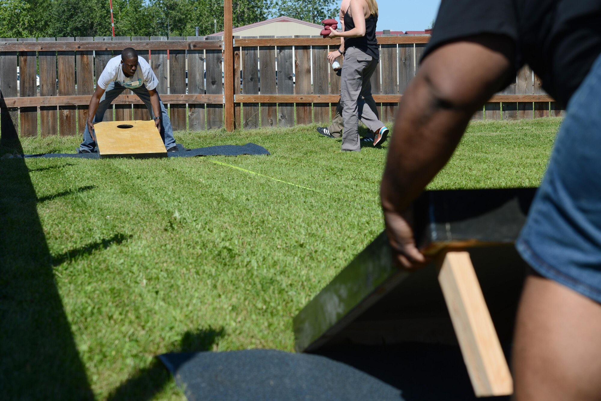 Facilitators set up cornhole boards for a tournament at the Warrior Zone at Joint Base Elmendorf-Richardson, Alaska, July 22, 2017. The tournament had a total of 18 teams and played a double-elimination bracket, meaning a team was eliminated if they lost twice. 