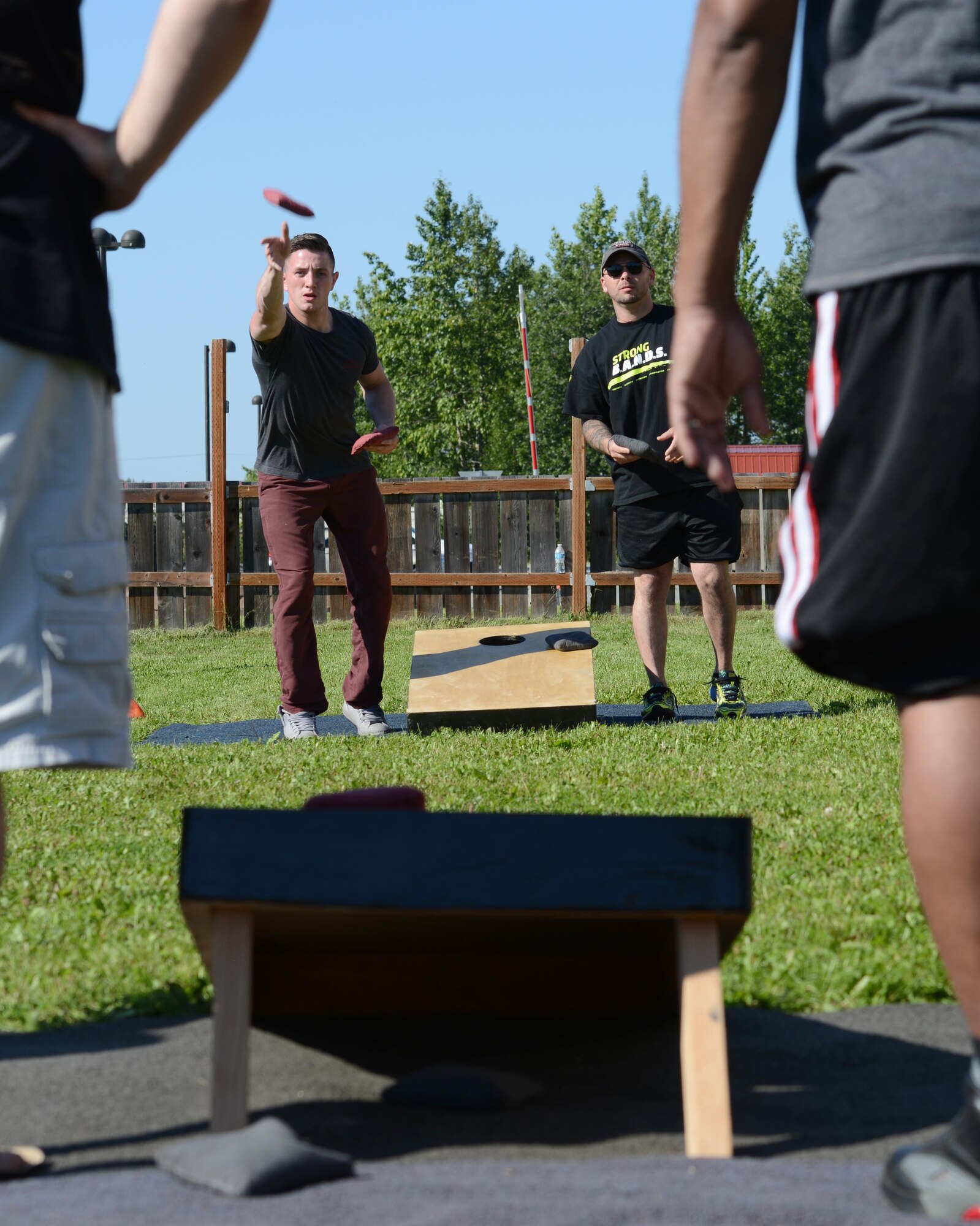 Matthew Knoll, first-place winner, throws a beanbag during a cornhole tournament at the Warrior Zone at Joint Base Elmendorf-Richardson, Alaska, July 22, 2017. The tournament had a total of 18 teams and played a double-elimination bracket, meaning a team was eliminated if they lost twice. 