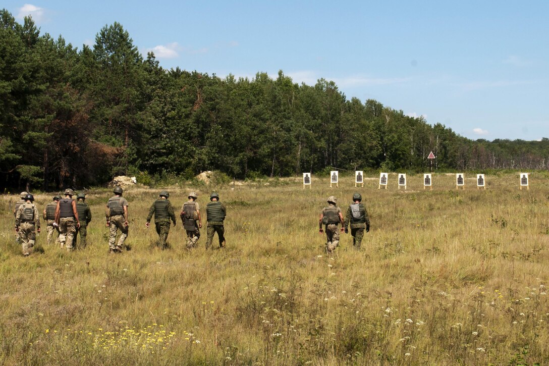 U.S. and Ukraine soldiers move to inspect their targets during rifle marksmanship training at the International Peacekeeping and Security Center in Yavoriv, Ukraine, July 31, 2017. Army photo by Staff Sgt. Eric McDonough


