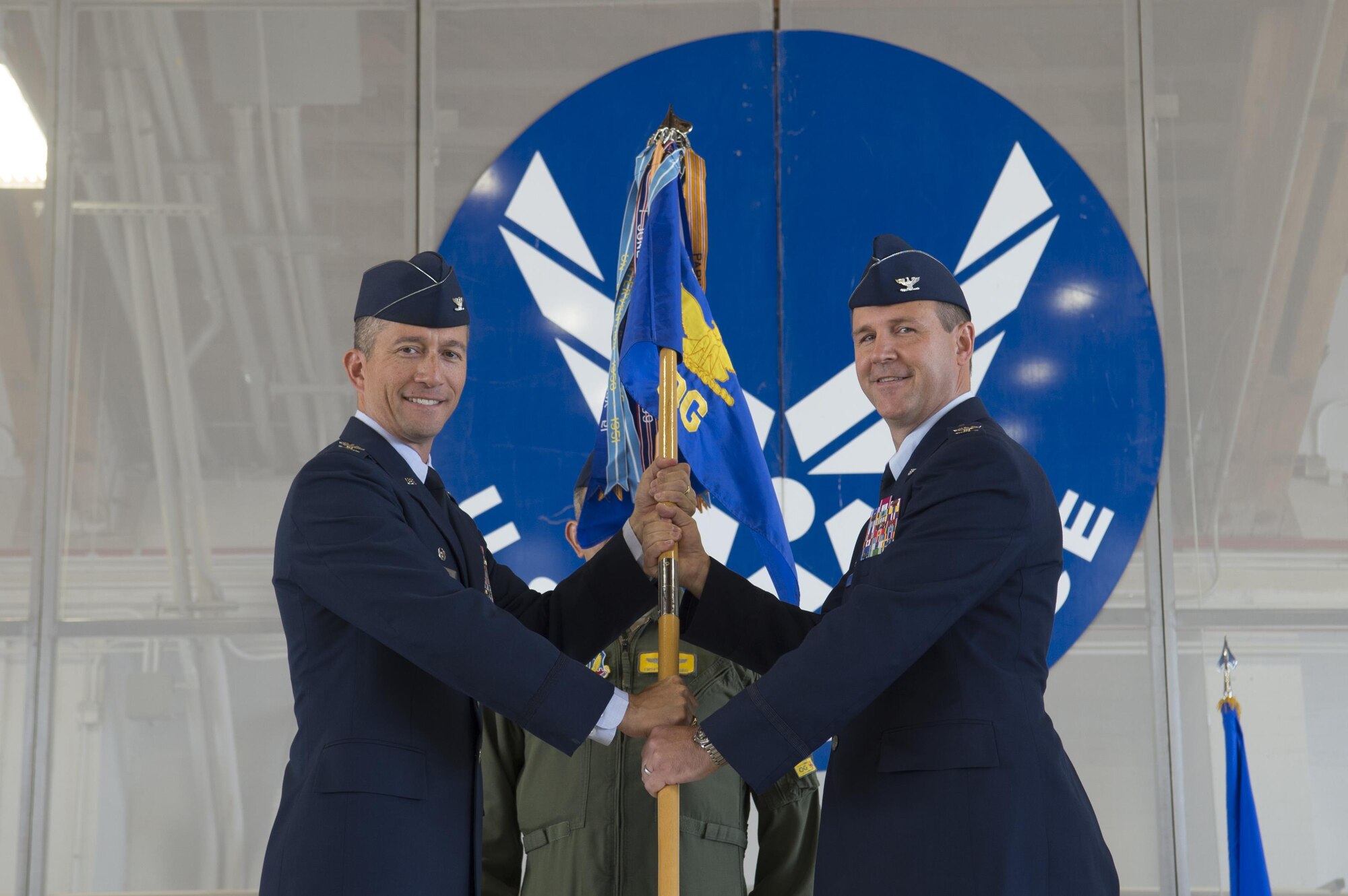 Col. Houston Cantwell, 49th Wing commander, gives the 49th Operations Group guidon to Col. Jeffery Patton during a change of command ceremony at Holloman Air Force Base, N.M., July 31, 2017. During the ceremony, Col. Patton took command of the 49th OG from Col. Ryan Sherwood, 49th OG outgoing commander. (U.S. Air Force photo by Tech. Sgt. Amanda Junk)