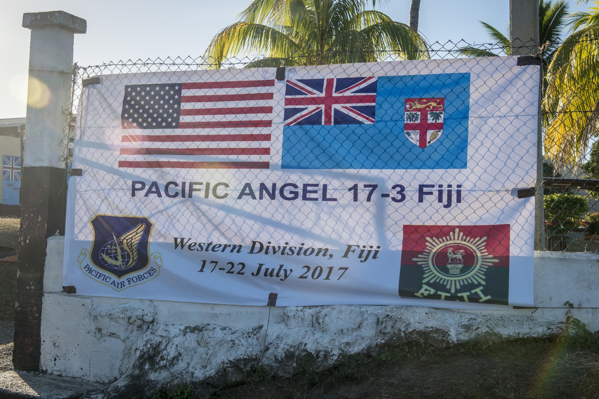 The Pacific Angel (PACANGEL) 17-3 banner sign waves in the wind as the sunsets at the Tagitagi Sangam School and Kindergarten in Tavua, Fiji, July 22, 2017. PACANGEL 17-3 built partnerships between the U.S., Fiji, and five regional nations including Australia, Vanuatu, Indonesia, the Philippines and France by conducting multilateral humanitarian assistance and civil military operations, promoting regional military-civilian-nongovernmental organization cooperation and interoperability. (U.S. Air Force photo/Tech. Sgt. Benjamin W. Stratton)