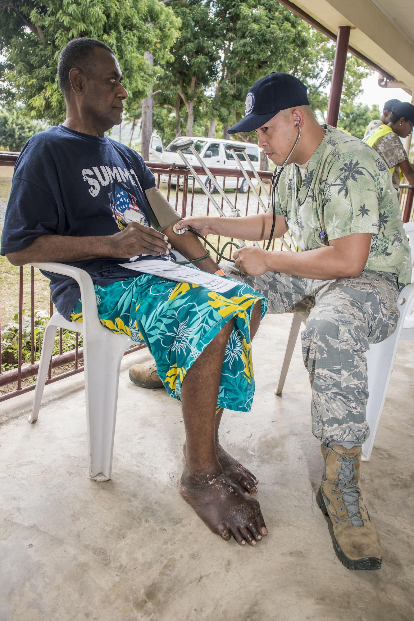 U.S. Air Force Tech. Sgt. Michael Ang, an aerospace medical services craftsman with the 18th Medical Operations Squadron at Kadena Air Base, Japan, evaluates a patient’s arthritis ridden foot while taking his vitals before sending to a specialist during Pacific Angel (PACANGEL) 17-3 at the Tagitagi Sangam School and Kindergarten in Tavua, Fiji, July 17, 2017. PACANGEL 17-3 built partnerships between the U.S., Fiji, and five regional nations including Australia, Vanuatu, Indonesia, the Philippines and France by conducting multilateral humanitarian assistance and civil military operations, promoting regional military-civilian-nongovernmental organization cooperation and interoperability. (U.S. Air Force photo/Tech. Sgt. Benjamin W. Stratton)