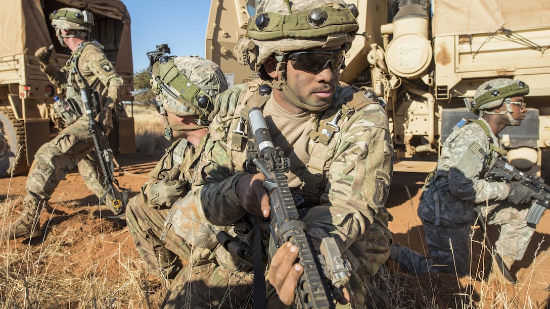 Army Pfc. Cameron Livingston, center, provides security as soldiers move a disabled vehicle as part of an attack scenario during the Shared Accord exercise at the South African Army Combat Training Center in Lohatla, South Africa, July 27, 2017. The attack tested Army truck drivers assigned to 101st Airborne Division's 2nd Battalion, 327th Infantry Regiment. Army photo