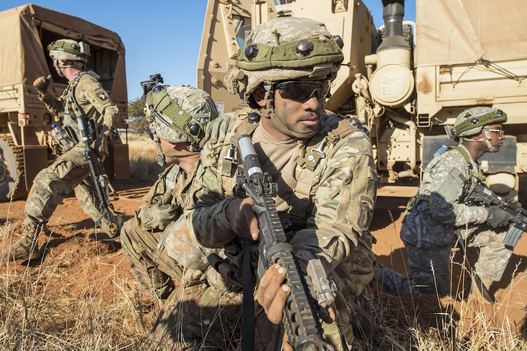Army Pfc. Cameron Livingston, center, provides security as soldiers move a disabled vehicle as part of an attack scenario during the Shared Accord exercise at the South African Army Combat Training Center in Lohatla, South Africa, July 27, 2017. The attack tested Army truck drivers assigned to 101st Airborne Division's 2nd Battalion, 327th Infantry Regiment. Army photo