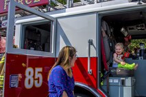 While he sits in a fire engine for the first time, his mom smiles back. A 96th Civil Engineer Group fire engine was on display and firefighters educated the public on fire safety at Big Truck Day, July 28, Destin, Fla. Fire, construction, garbage and light power trucks were on display for kids to see up close at the city’s annual event. (U.S. Air Force photo/Kristin Stewart)