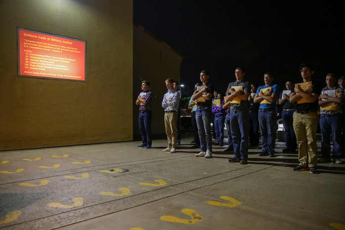 New recruits of Delta Company, 1st Recruit Training Battalion, stand on the yellow footprints before receiving a Uniform Code of Military Justice brief at Marine Corps Recruit Depot San Diego, July 24. At this point, recruits are informed of the articles of the UCMJ that apply to them while they are in recruit training. Annually, more than 17,000 males recruited from the Western Recruiting Region are trained at MCRD San Diego. Delta Company is scheduled to graduate Oct. 20.