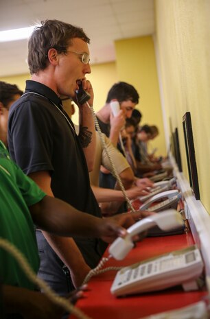 Recruits from Delta Company, 1st Recruit Training Battalion, make their phone calls home, reading only what is printed on the script in front of them, during receiving at Marine Corps Recruit Depot San Diego, July 24. Recruits will not be able to make another phone call until the end of recruit training. Annually, more than 17,000 males recruited from the Western Recruiting Region are trained at MCRD San Diego. Delta Company is scheduled to graduate Oct. 20.