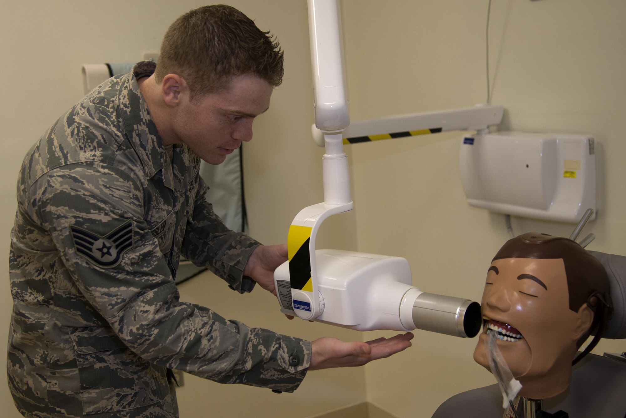 Staff Sgt. Brandon Issler, a 932nd Aerospace Medical Squadron dental technician, practices X-raying a “patient’s” teeth at the Vance Clinic July 24. Each year, the 932nd AMDS takes two weeks for annual tour training with an active duty medical group. (U.S. Air Force photo/ Airman Zachary Heal)