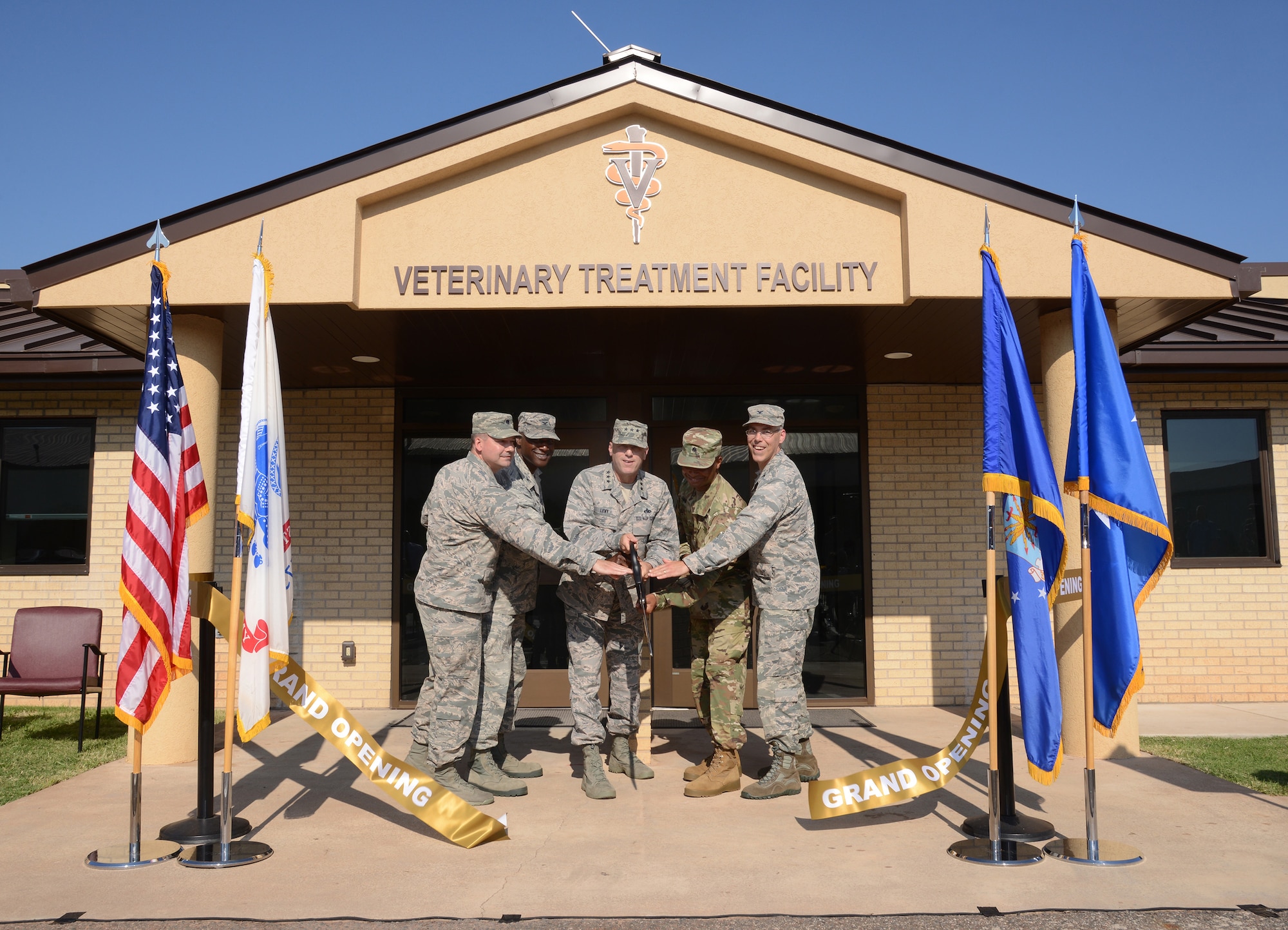 From left, 72nd Medical Support Squadron Commander Lt. Col. Jeffrey Fewell, 72nd Air Base Wing Commander Col. Kenyon Bell, Air Force Sustainment Center Commander Lt. Gen. Lee K. Levy II, Public Health Activity Commander at Fort Hood Lt. Col. Sydney Cobb and 72nd Medical Group Commander Col. Christopher Grussendorf cut the ceremonial ribbon at the newly remodeled Veterinary Treatment Facility on the south side of Tinker July 17, 2017. As a joint partnership between the U.S. Army Medical Department's Veterinary Corps and the AFSC, 72nd ABW, 72nd MDG, 72nd Force Support Squadron and 72nd Security Forces Squadron, the clinic has increased its capabilities of care to further support Military Working Dogs as well as family pets for military members and retirees. (Air Force photo by Kelly White)