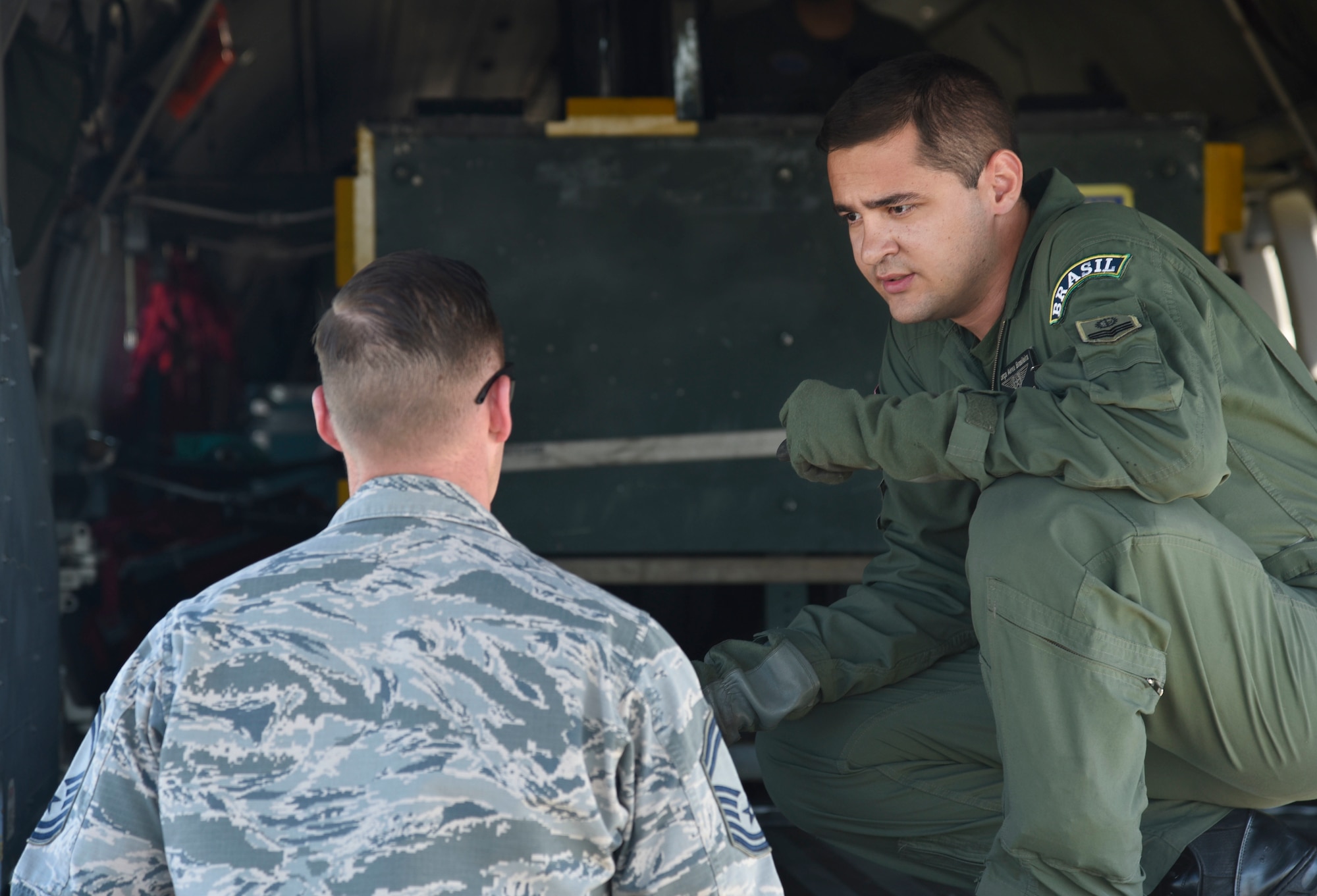 Senior Master Sgt. Joseph Wallis, 62nd Aircraft Maintenance Squadron lead production superintendent, talks with a member of the Brazilian air force's 5th Wing at Joint Base Lewis-McChord, Wash., July 29, 2017. More than 3,000 Airmen, Soldiers, Sailors, Marines and international partners converged on the state of Washington in support of Mobility Guardian. The exercise is intended to test the abilities of the Mobility Air Forces to execute rapid global mobility missions in dynamic, contested environments. Mobility Guardian is Air Mobility Command's premier exercise, providing an opportunity for the Mobility Air Forces to train with joint and international partners in airlift, air refueling, aeromedical evacuation and mobility support. (U.S. Air Force photo by Airman 1st Class Erin McClellan)