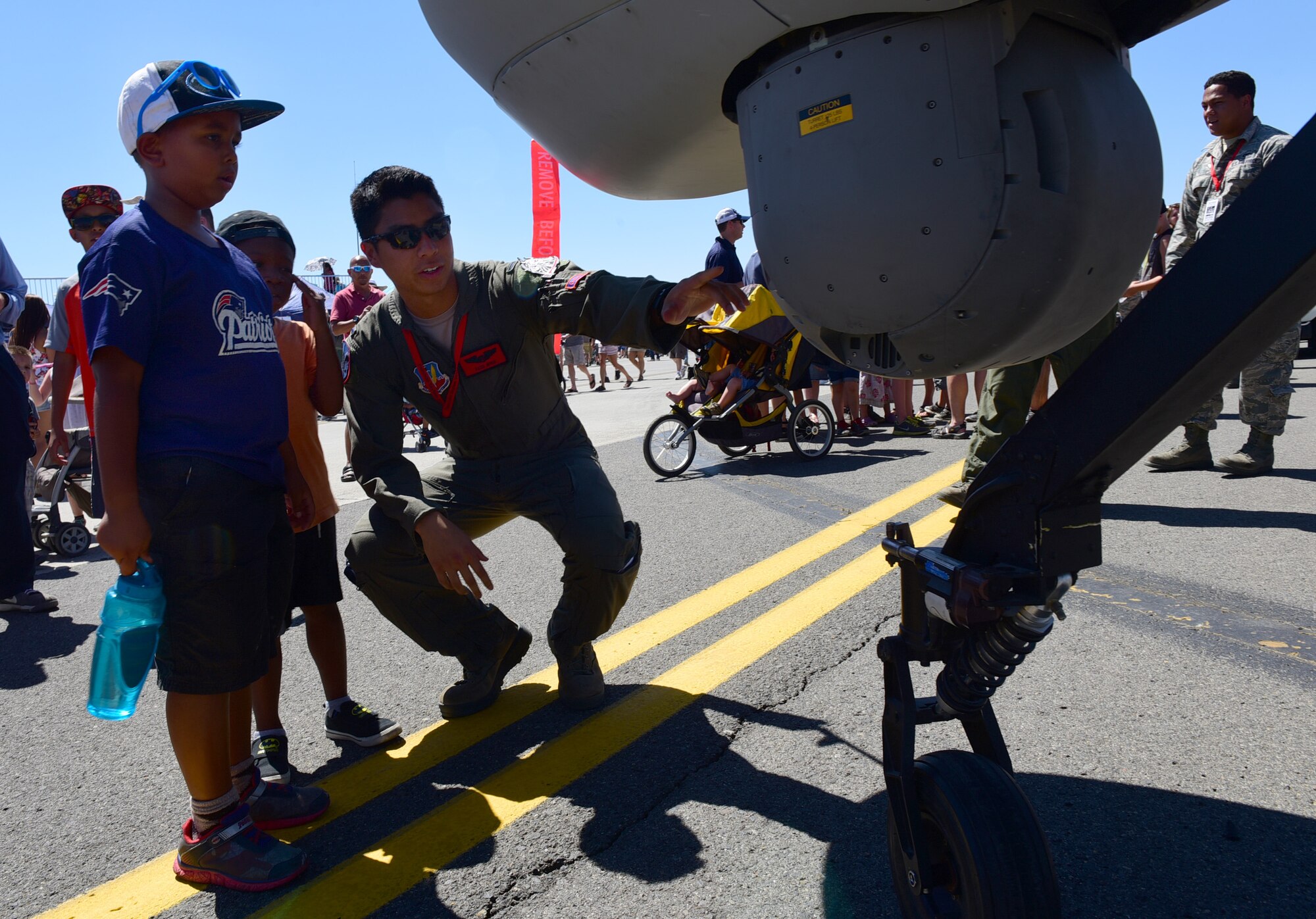 1st LT. Donald, 17th Attack Squadron pilot, shows a child the Multi-Spectral Targeting System at the Skyfest air show, July 29-30, 2017, at Fairchild Air Force Base, Washington. During the show, Airmen were able to answer questions regarding how the MQ-1 can accomplish its missions. (U.S. Air Force photo/Senior Airman Christian Clausen)