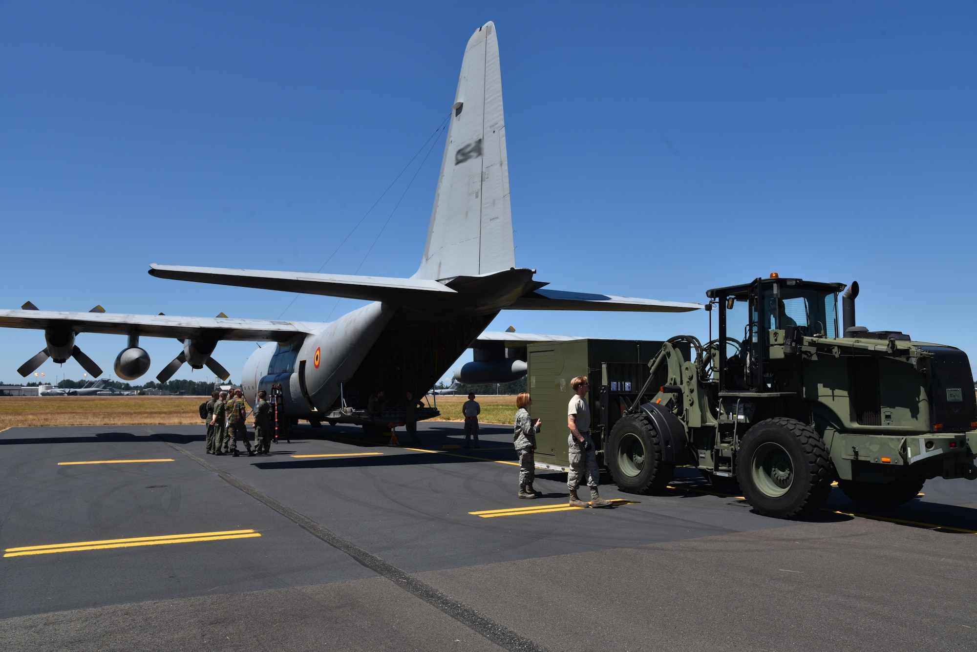 The 86th Aerial Port Squadron assists the Belgian Air Component 15th Air Transport Wing 20th Squadron with offloading cargo during their arrival to Mobility Guardian, Joint Base Lewis-McChord, Wash., July 28, 2017.  Mobility Guardian is Air Mobility Command's premier exercise, providing an opportunity for the Mobility Air Forces to train with joint and international partners in airlift, air refueling, aeromedical evacuation and mobility support. (U.S. Air Force photo manipulation by Staff Sgt. Jael Laborn)