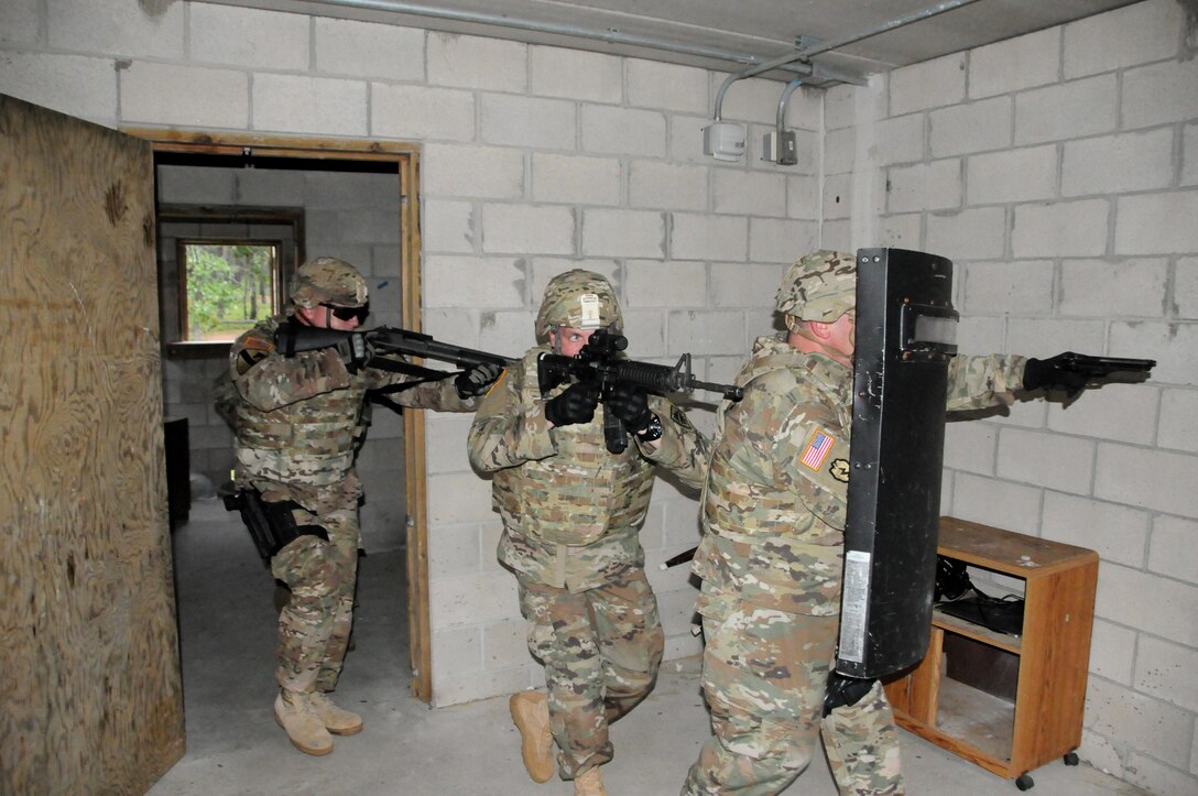Sgt. 1st Class Robert Meola (left), Sgt. 1st Class Ronald Clifton and Staff Sgt. Kevin Patti (right) breach and clear a room July 25 during a photoshoot at the urban assault course on Joint Base McGuire-Dix-Lakehurst, New Jersey.  The photoshoot was with Army Reserve Communications, Army Marketing and Research Group and United States Army Recruiting Command.  They are currently assigned to the U.S. Army Reserve’s 430th Military Police Detachment.