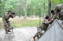 Master Sgt. Michel Sauret, a public affairs noncommissioned officer with the U.S. Army Reserve’s 200th Military Police Command, takes pictures July 27 as Soldiers go over the inclined wall on the Joint Base McGuire-Dix-Lakehurst, New Jersey obstacle course.  The Soldiers were recently flown into JBMDL for a photoshoot with Army Reserve Communications, Army Marketing and Research Group and United States Army Recruiting Command.  They’ll be featured on upcoming commercials and posters.