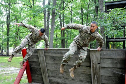 Sgt. Andrew Paredes (right) and Sgt. Ian Rivera-Aponte are photographed July 27 on the obstacle course at Joint Base McGuire-Dix-Lakehurst, New Jersey.  The Soldiers were recently flown into JBMDL for a photoshoot with Army Reserve Communications, Army Marketing and Research Group and United States Army Recruiting Command.  They’ll be featured on upcoming commercials and posters.