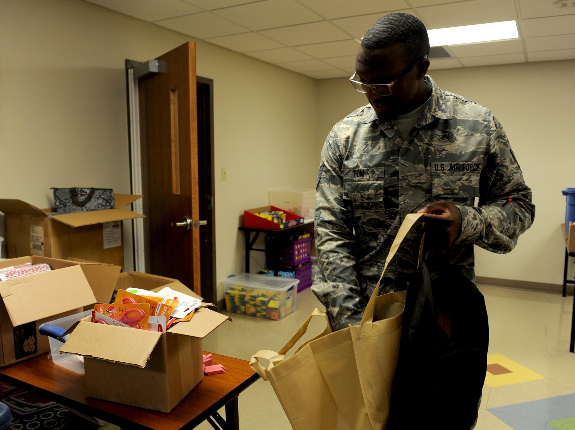 Staff Sgt. Moses Tum, 184th Air National Guard comptroller, selects school supplies during the School Supply Giveaway, July 31, 2017, at McConnell Air Force Base, Kan. The supply giveaway is free and open to all military families E-5 and below with school age children. The giveaway is scheduled to run July 31 through August 4 from 10 a.m. to 2 p.m. (U.S. Air Force photo/Staff Sgt. Rachel Waller)