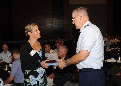 Isabelle Desmartis, Canadian Department of National Defence director general of policy planning, receives a momento from U.S. Air Force Gen. John. E. Hyten, commander of U.S. Strategic Command (USSTRATCOM), following a presentation during USSTRATCOM’s annual Deterrence Symposium at the CenturyLink Center, Omaha, Neb., July 27, 2017. Desmartis highlighted the deterrence concepts embedded in Canada’s new national defense policy. During the two-day symposium, industry, military, governmental, international and academic experts discussed and promoted increased collaboration to address 21st century strategic deterrence.  One of nine Department of Defense unified combatant commands, USSTRATCOM has global strategic missions assigned through the Unified Command Plan that include strategic deterrence, space operations, cyberspace operations, joint electronic warfare, global strike, missile defense, intelligence, and analysis and targeting.
