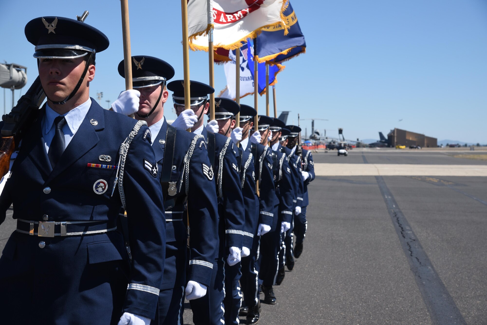 Fairchild Air Force Base Honor Guard members march down the flightline during Fairchild Air Force Base's SkyFest 2017 Air Show and Open House July 30, 2017, at FAFB, Washington. The Honor Guard presented the colors during SkyFest's opening remarks. Fairchild HG Airmen are responsible for providing military funeral honors for deceased Air Force members and provide colors details for various events. (U.S. Air Force photo/Senior Airman Nick J. Daniello)