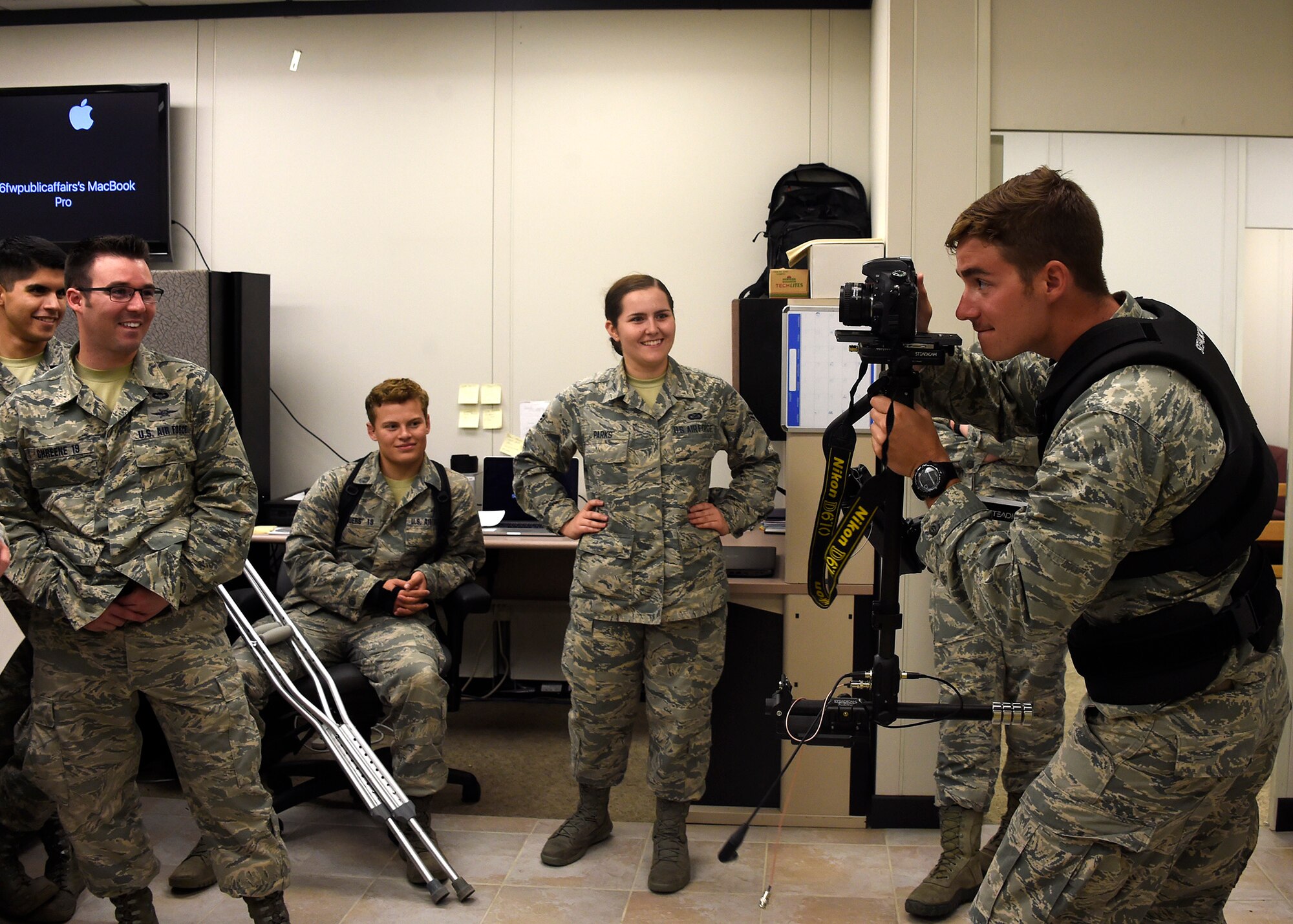 A U.S. Air Force Academy cadet uses a camera chest mount to document other cadets during their tour July 31, 2017 at Luke Air Force Base, Ariz. The purpose of the tour was to allow the cadets to shadow officers and enlisted and increase their understanding of what it will be like as a junior officer in the United States Air Force. (U.S. Air Force photo by Senior Airman Devante Williams)  