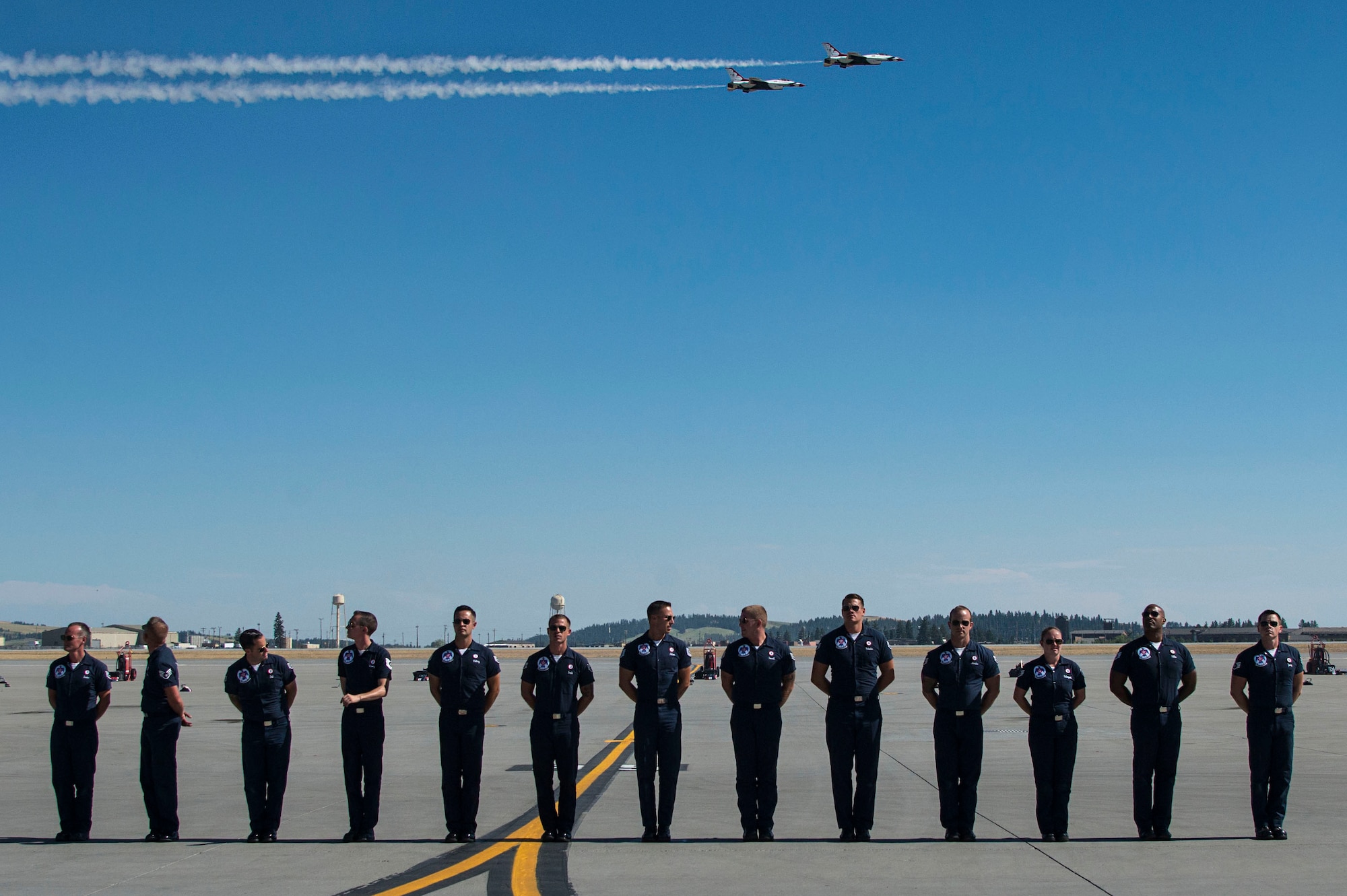 Members of the U.S. Air Force Aerial Demonstration Squadron “Thunderbirds” stand by as the Thunderbirds fly in formation during SkyFest 2017 Air Show and Open House at Fairchild Air Force Base, Washington, July 28, 2017. SkyFest hosted more than 15 types of aircraft and static displays and more than 10 flying performers. (U.S. Air Force photo/Senior Airman Janelle Patiño)